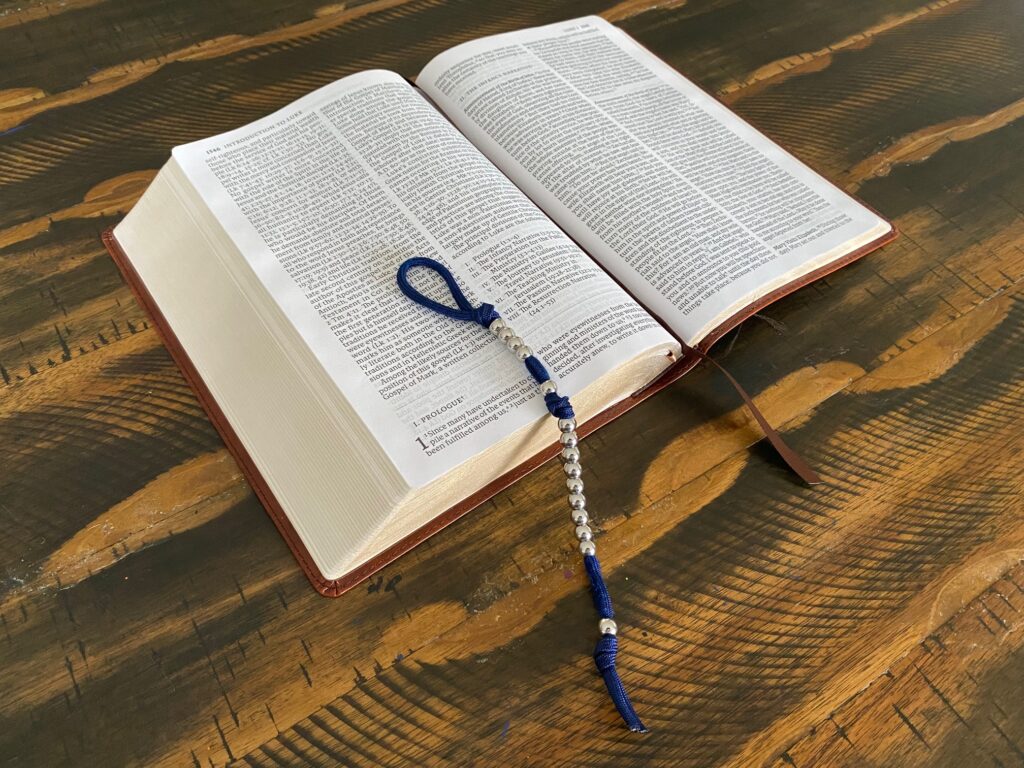 A Field Rosary displayed on top of an open bible.