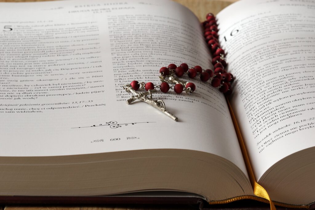 Rosary laid across open bible